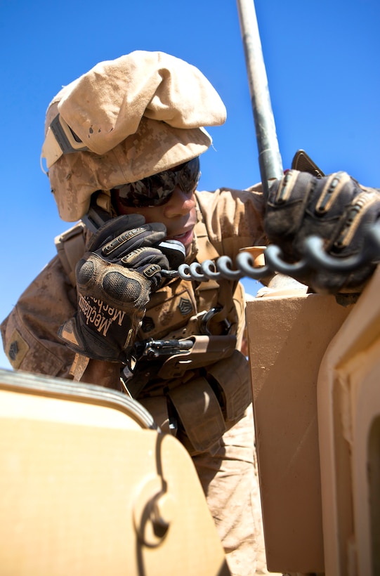 U.S. Marine Corps Gunnery Sgt. Chauncy J. Anderson radios to his convoy while helping to recover a downed vehicle during a combat logistics patrol in Helmand province, Afghanistan, Oct. 2, 2013. Anderson, a motor transportation chief, is assigned to Combat Logistics Regiment 2, Regional Command Southwest.