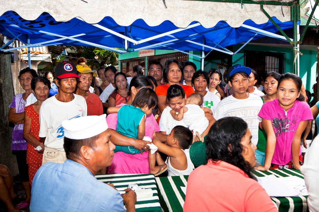 Filipino residents register for treatment during a cooperative health event in Victory Village, Legazpi, Albay province, Philippines, Oct. 1, 2013. The event is part of Amphibious Landing Exercise 14.