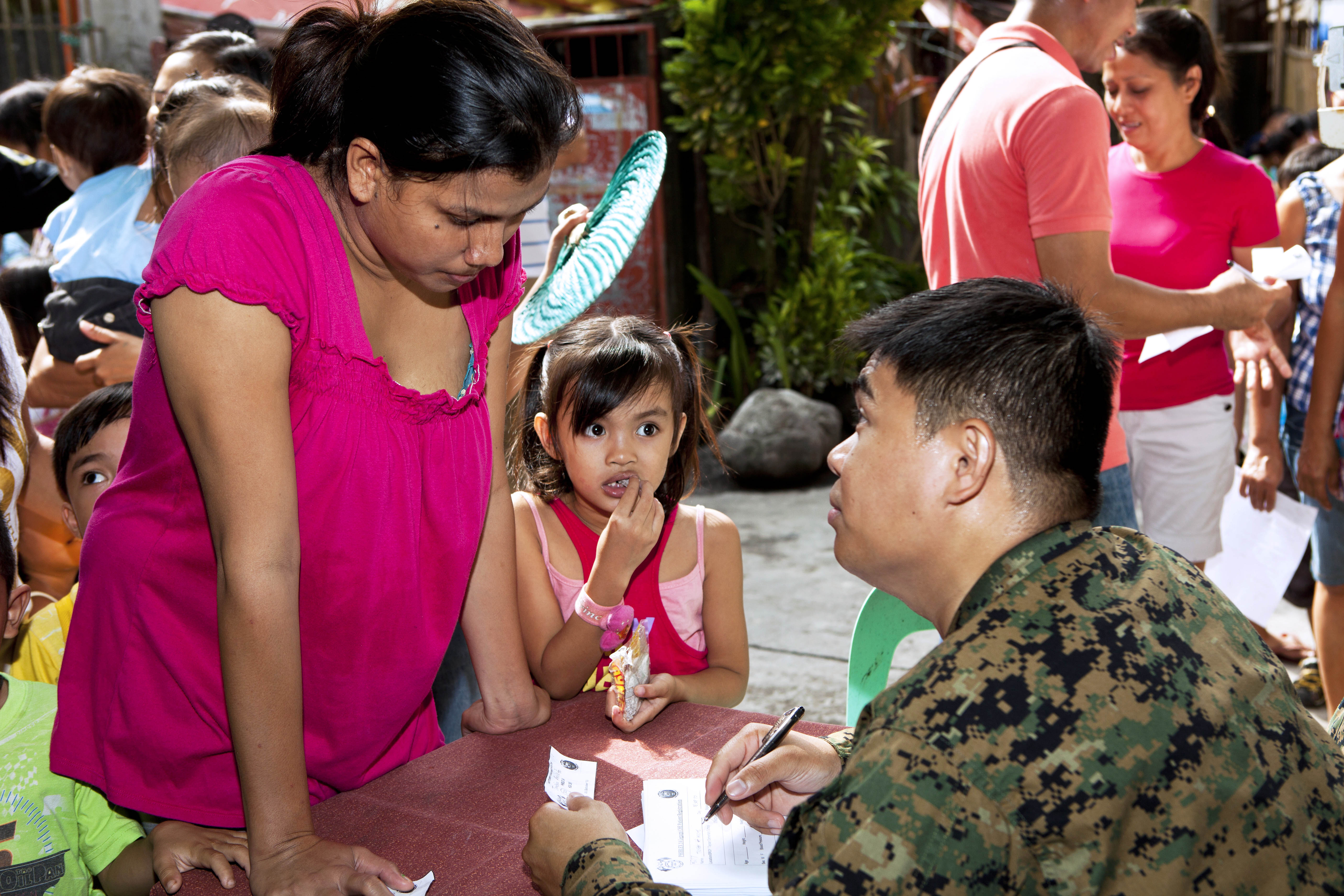 U.S. Navy Petty Officer 3rd Class Neil Domingo registers Filipino ...