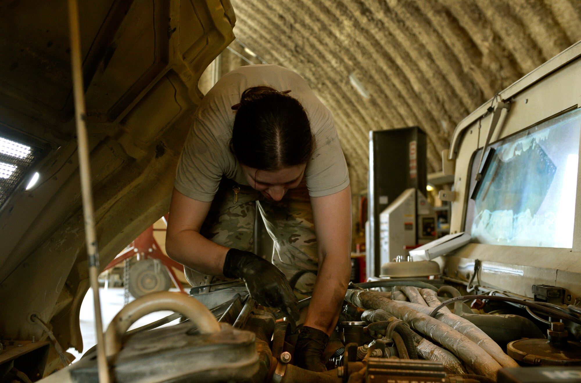 Staff Sgt. Anne Lynn, a 455th Expeditionary Logistics Readiness Squadron vehicle maintainer, replaces a belt in a mine resistant ambush protection vehicle on Bagram Airfield, Afghanistan. She is deployed from Nellis Air Force Base, Nev. (U.S. Air Force photo/ Staff Sgt. Stephenie Wade)
