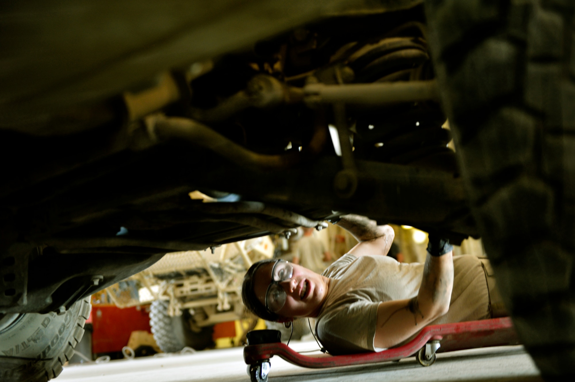 Staff Sgt. Anne Lynn, a 455th Expeditionary Logistics Readiness Squadron vehicle maintainer, examines a vehicle prior to repairing it on Bagram Airfield, Afghanistan. She is deployed from Nellis Air Force Base, Nev. (U.S. Air Force photo/ Staff Sgt. Stephenie Wade)