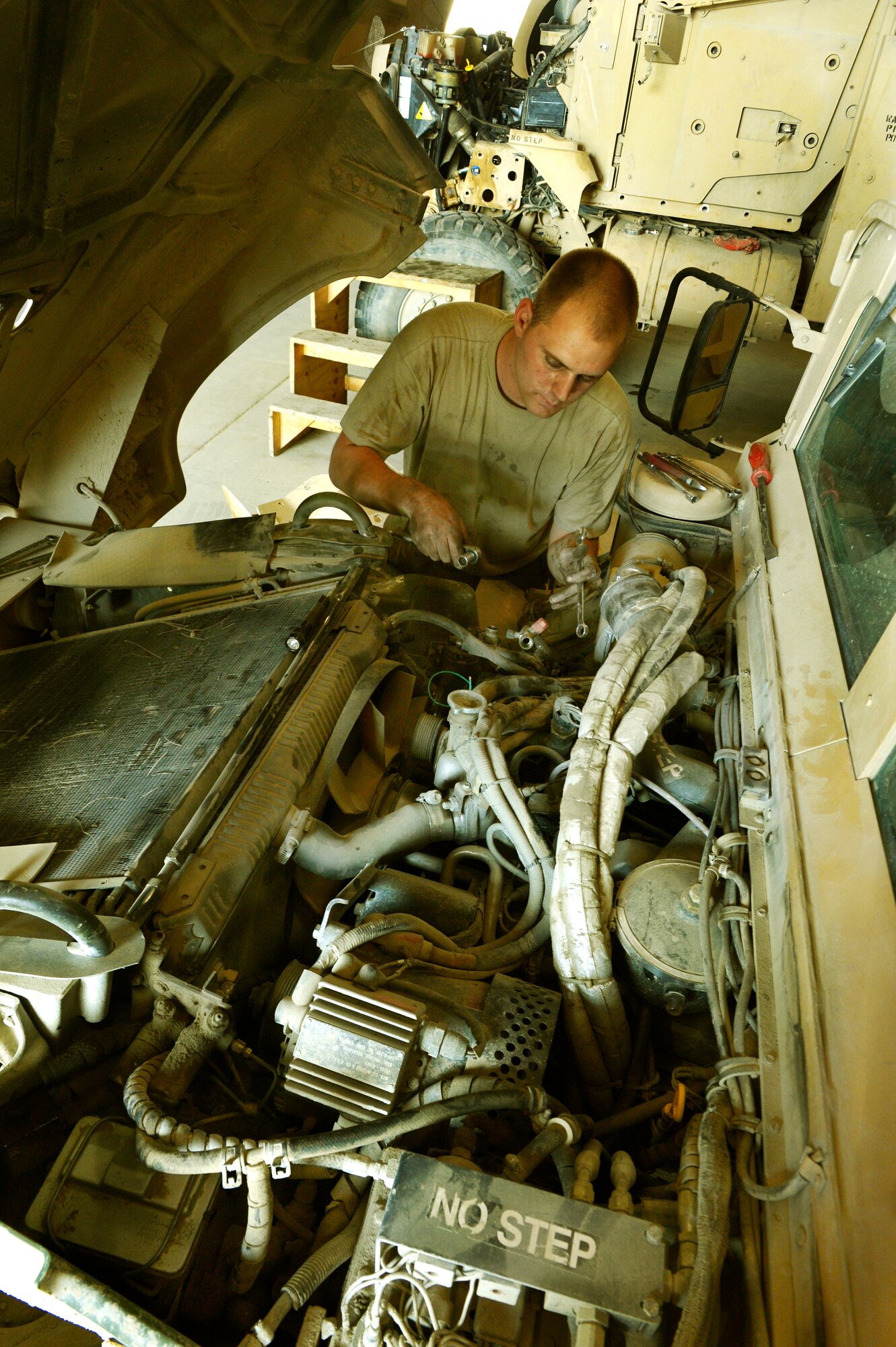 Staff Sgt. Andrew Sterrett, a 455th Expeditionary Logistics Readiness Squadron vehicle maintainer, repairs a mine resistant ambush protection vehicle’s air compressor on Bagram Airfield, Afghanistan. He is deployed from Shaw Air Force Base, N.C. (U.S. Air Force photo/ Staff Sgt. Stephenie Wade)