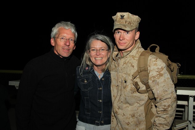 Petty Officer 3rd Class Colin Kroeker, corpsman, L Co., 3rd Battalion, 4th Marines, reunites with his parents, Michael and Melissa, during a homecoming at Del Valle Field Oct. 9, 2013.

