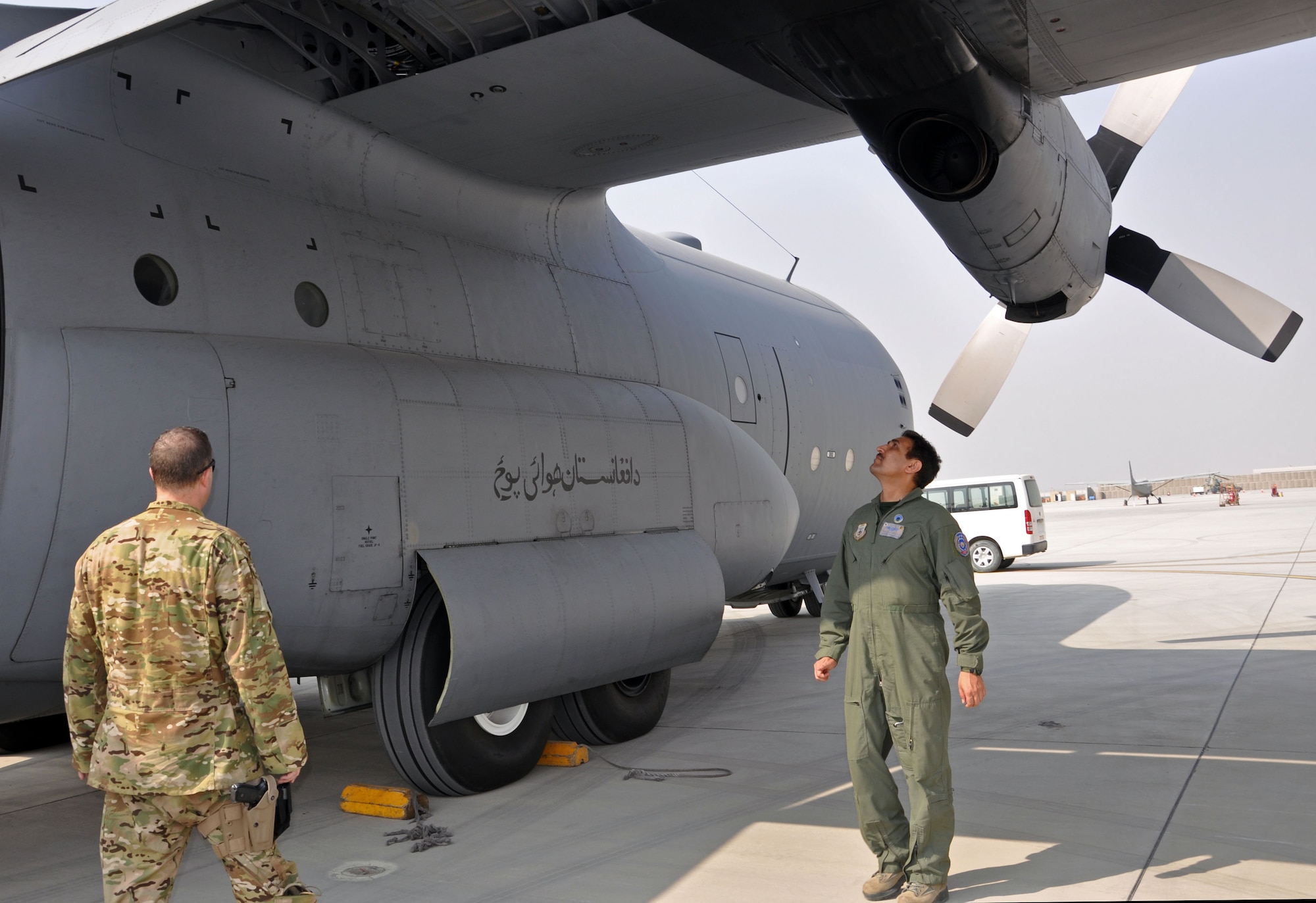 Afghan Air Force Col. Almal Pacha, one of two AAF C-130 pilots, and Maj. Chris Garcia, 538th Air Expeditionary Advisory Squadron C-130 pilot and advisor, look over the aircraft prior to the first operational  AAF C-130 mission Oct. 10, 2013 at Kabul International Airport, Afghanistan. The first operational mission was flown by both AAF and coalition pilots with NATO Air Training Command-Afghanistan between Kabul International Airport, Afghanistan and Kandahar Airfield, Afghanistan. (U.S. Air Force photo/Capt. Anastasia Wasem)