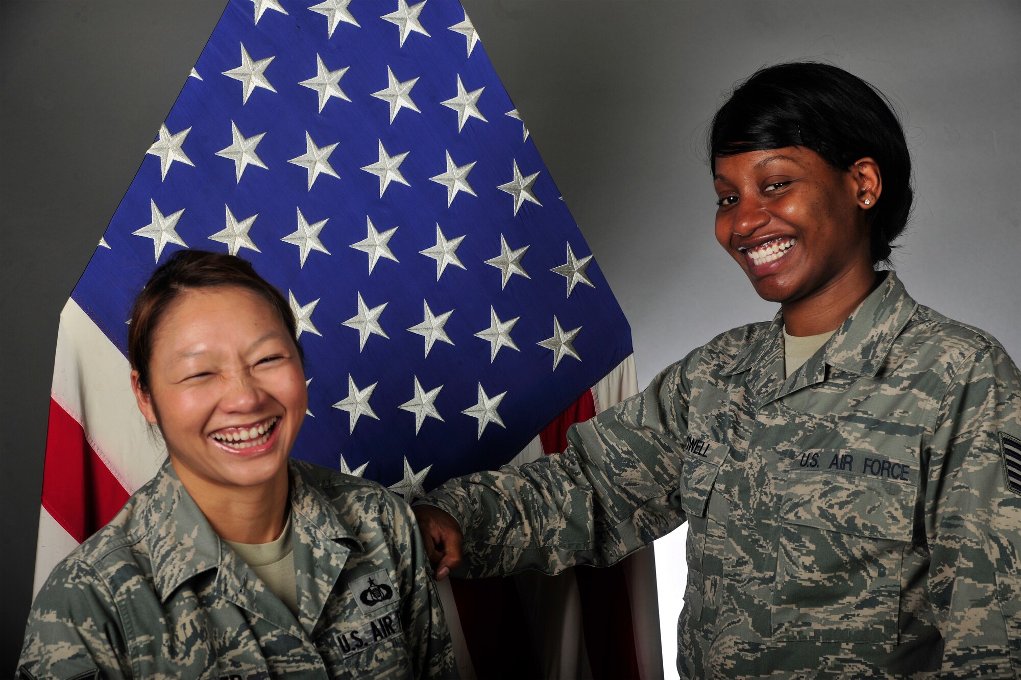 Tech. Sgt. Kim Powell (right), 35th Fighter Squadron Aviation Resource Manager NCO in-charge, ‘tacks on rank’ for her Airman, Staff Sgt. Janelle Smith (left), 35th FS Aviation Resource Manager, at Kunsan Air Base, Republic of Korea, Oct. 10, 2013. Powell was selected as Kunsan’s Pride of the Pack for her efforts in correcting an error that prevented her Airman, Smith, from being promoted on time. (U.S. Air Force photo by Staff Sgt. Jessica Haas/Released)