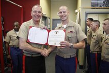 Maj. Gen. Mark A. Brilakis, Marine Corps Recruiting Command commanding general, and Sgt. David A. Ouimet, a Recruiting Station Kansas City, Recruiting Sub-Station Gladstone recruiter, smiles for the camera after Brilakis presented Quimet with the Navy and Marine Corps Achievement Medal at RSS Gladstone Oct. 9, 2013. Ouimet was presented the medal for his efforts as a recruiter, helping to contribute to the success of the RS.