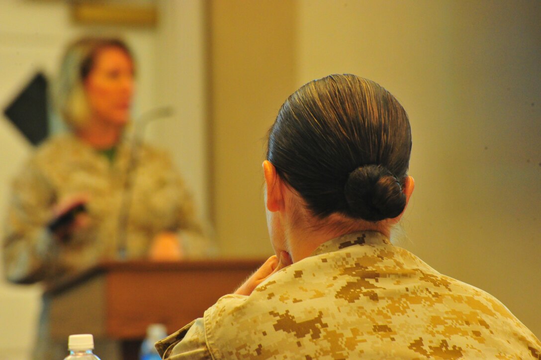 A Marine listens as Chief Warrant Officer Dancy Simons, trial services administrative officer, gives a brief on legal policy at The Clubs at Quantico on Oct. 10, 2013. More than two-dozen service members attended the brief as a refresher course for current legal issues.