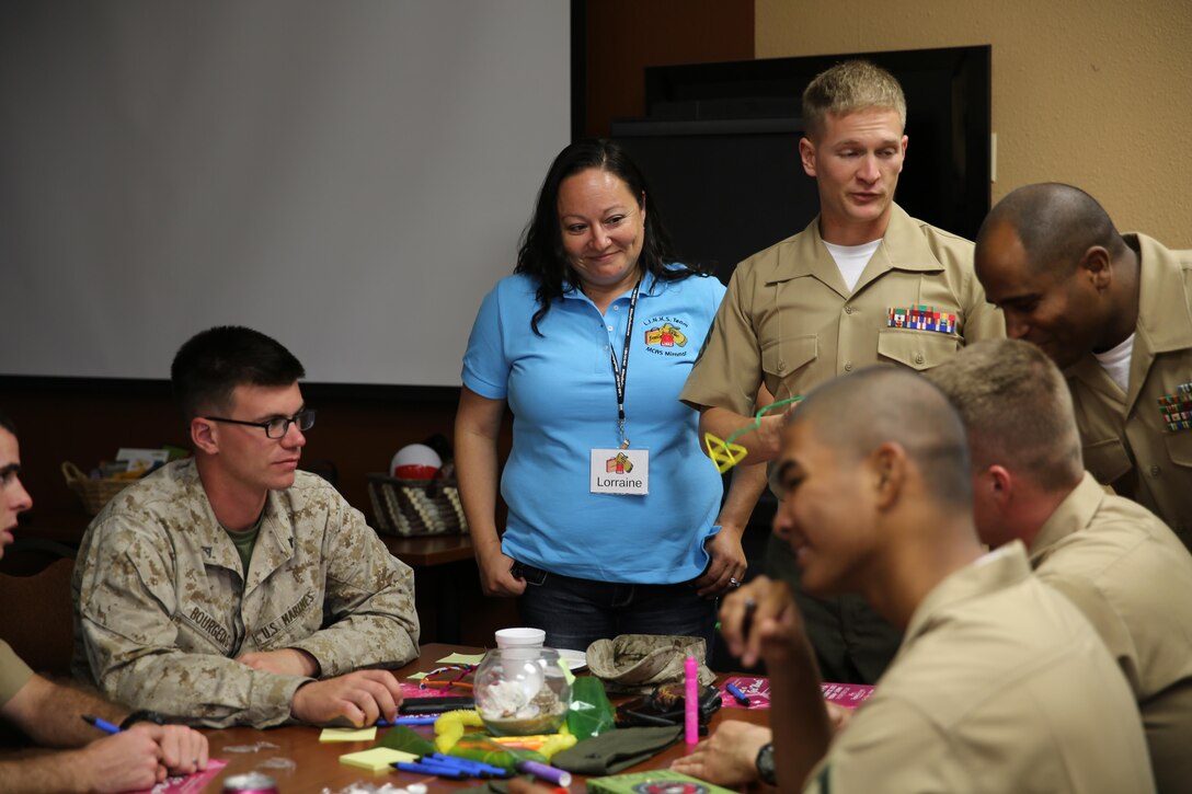 Lorraine Nisbet, a Marine spouse and active volunteer, teaches a class to Marines how to prepare for a move aboard Marine Corps Air Station Miramar, Calif., Sep. 20. As part of the Committed and Engaged Leadership Initiative, spouses like Nisbet are being recognized for their work giving back to the community.