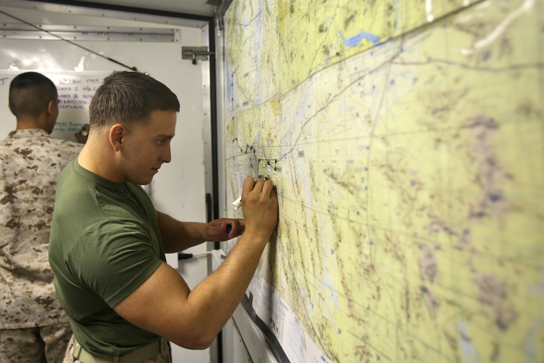 Lance Cpl. Jacob A. Barkstrom, a data network systems technician with Combat Logistics Company 16, Combat Logistics Regiment 15, 1st Marine Logistics Group, maps out the locations of friendly forces in a combat operations center during Weapons and Tactics Instructor Course 1-14 aboard Marine Corps Air Station Yuma, Ariz., Oct. 2, 2013. The COC provided logistical support and services to units from 1st MLG including CLR-15, CLR-1, CLR-17, 7th Engineer Support Battalion, 1st Maintenance Battalion and 1st Medical Battalion during WTI 1-14. 