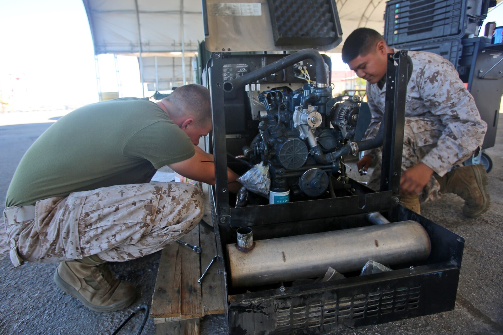 Heavy equipment mechanics with Combat Logistics Company 16, Combat Logistics Regiment 15, 1st Marine Logistics Group, repair a generator at a combat operations center during Weapons and Tactics Instructor Course 1-14 aboard Marine Corps Air Station Yuma, Ariz., Oct. 2, 2013. The COC provided logistical support and services to units from 1st MLG including CLR-15, CLR-1, CLR-17, 7th Engineer Support Battalion, 1st Maintenance Battalion and 1st Medical Battalion during WTI 1-14. 