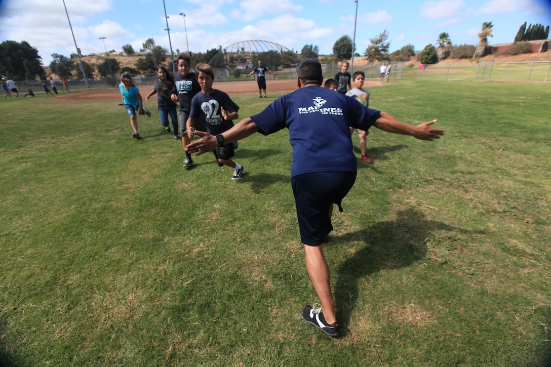 Gunnery Sgt. Andres Zayas, an airframes mechanic with Marine Air Group 39, leads fifth graders from Del Rio Elementary School in exercises as part of a program called the Walking Club. Zayas has volunteered since the beginning of the program, last spring.