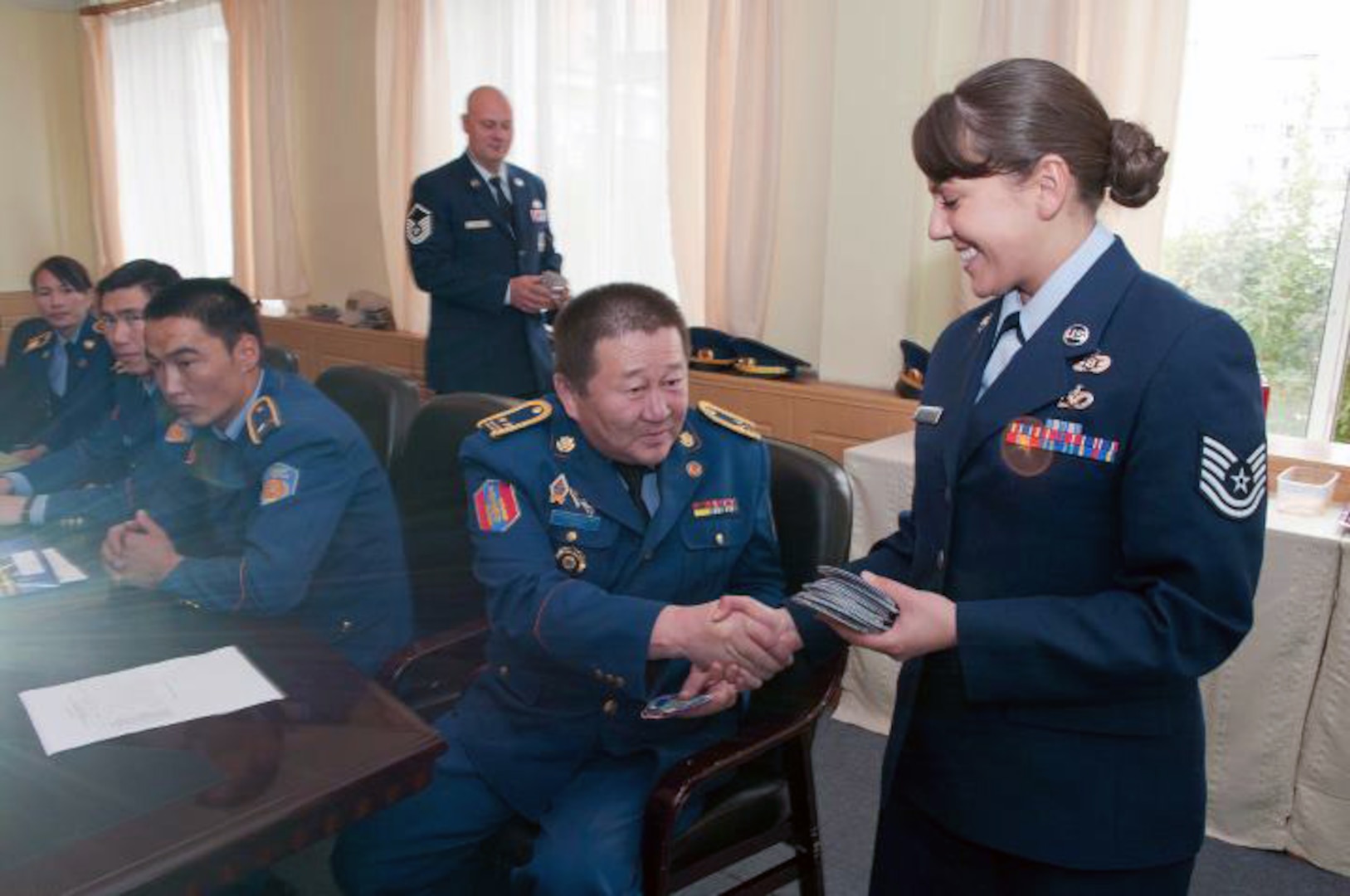 Air Force Tech. Sgt. Nina Kolyvanova, survey team chief for the Alaska National Guard's Joint Forces Headquarters, hands out tokens of appreciation to members of the National Emergency Management Agency during the Alaska National Guard HAZMAT exchange. Kolyvanova and three other Alaska National Guard members traveled to Mongolia to participate in the exchange.