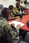 Air Force Chief Master Sgt. Neville Lee, the Virgin Islands National Guard counterdrug coordinator, discusses strategies to reduce gang violence and proliferation with members of the Regional Security System, a treaty organization for defense in the Caribbean, Aug. 31, 2011. As part of the National Guard's State Partnership Program, Guard members from the Florida and Virgin Islands National Guards participated in a subject matter expert exchange addressing youth and gang violence in the Caribbean.