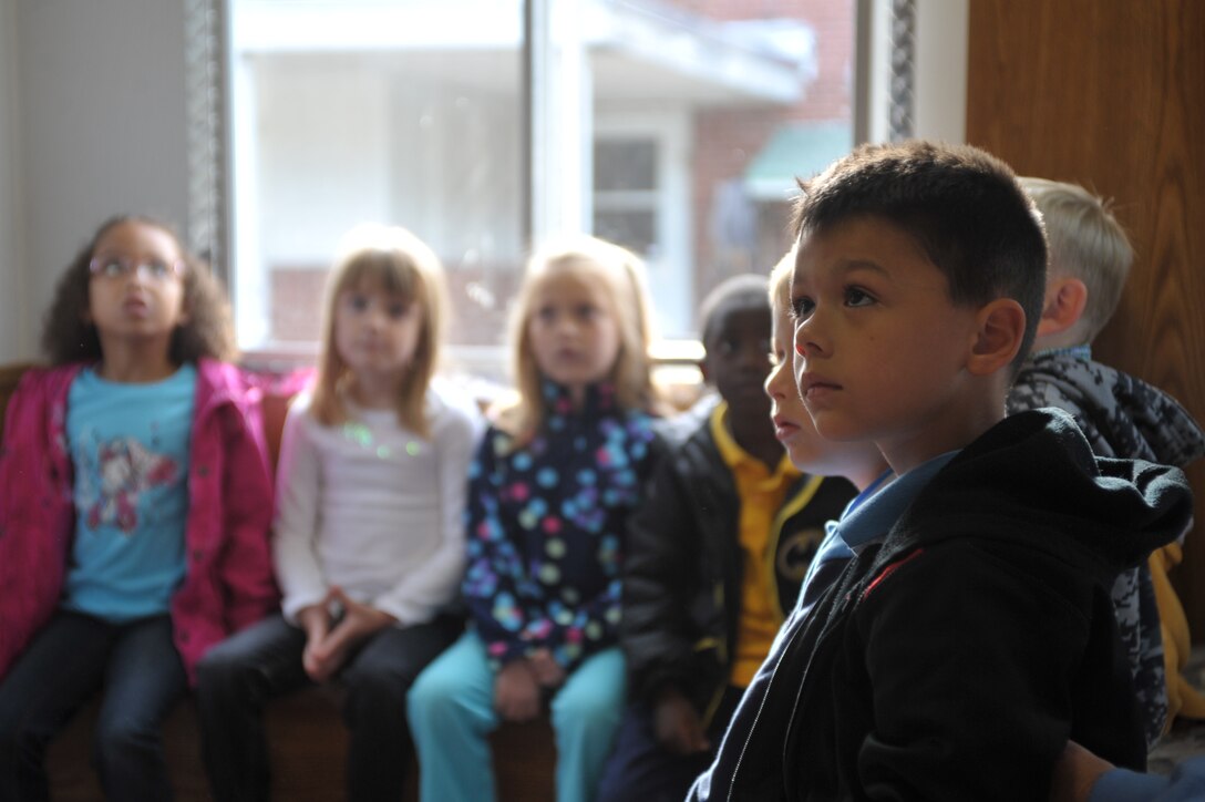 Students from John H. Russell Elementary listen to a fire safety brief, given by a fire instructor from Quantico Fire and Emergency Services on Oct. 8, 2013. The students were in the smokehouse when harmless smoke was pumped in to it to simulate a burning house.  