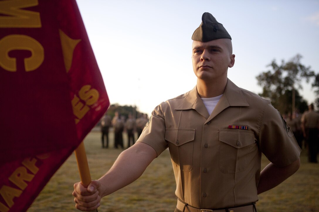 Cpl. Lance Decker, an administrative clerk with Headquarters Battalion, Marine Forces Reserve, holds the Headquarters Bn. guidon before the start of a military appearance inspection at the Marine Corps Support Facility New Orleans, Oct. 11, 2013. Lt. Gen. Richard P. Mills, commander of MARFORRES and Marine Forces North published a force policy letter to be implemented by his Marines without delay, addressing the commandant's initiatives to get back to the basics.