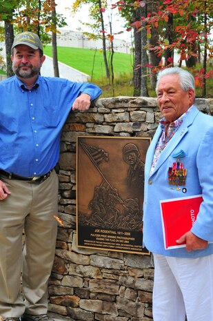 Participants of the Joe Rosenthal plaque dedication ceremony posed for a picture around the plaque at the National Museum of the Marine Corps on Oct. 10, 2013. The ceremony was held on the 102nd anniversary of Rosenthal’s birthday. 