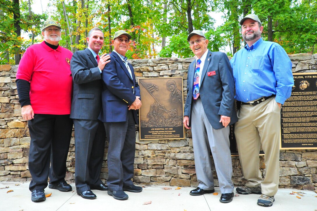 Participants of the Joe Rosenthal plaque dedication ceremony posed for a picture around the plaque at the National Museum of the Marine Corps on Oct. 10, 2013. The ceremony was held on the 102nd anniversary of Rosenthal’s birthday.