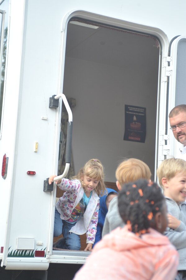 Strand 5, exits the smokehouse after a fire safety brief given by a fire instructor at the John H. Russell Elementary School on Oct. 8, 2013. The smokehouse was pumped full of harmless smoke to simulate a burning house for the students.