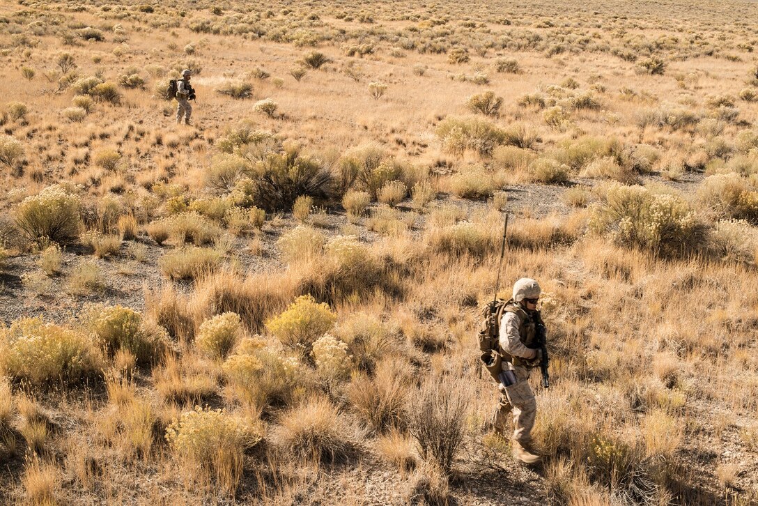 U.S. Marine joint terminal attack controllers, forward air controllers and radio operators from the 1st Air Naval Gunfire Liaison Company Supporting Arms Liaison Team Delta, from Camp Pendleton, Calif., move across a field as they prepare to assault an exercise enemy during exercise Mountain Roundup 2013 at Juniper Butte Range, about 70 miles from Mountain Home Air Force Base, Idaho, Oct. 8, 2013. JTACs can change the course of any firefight or any enemy worldwide in a defensive posture by deterring the enemy from firing on friendly forces, or can go kinetic and make sure those insurgents will never fire on a friendly soldier again.  (U.S. Air Force photo by Master Sgt. Kevin Wallace/RELEASED)