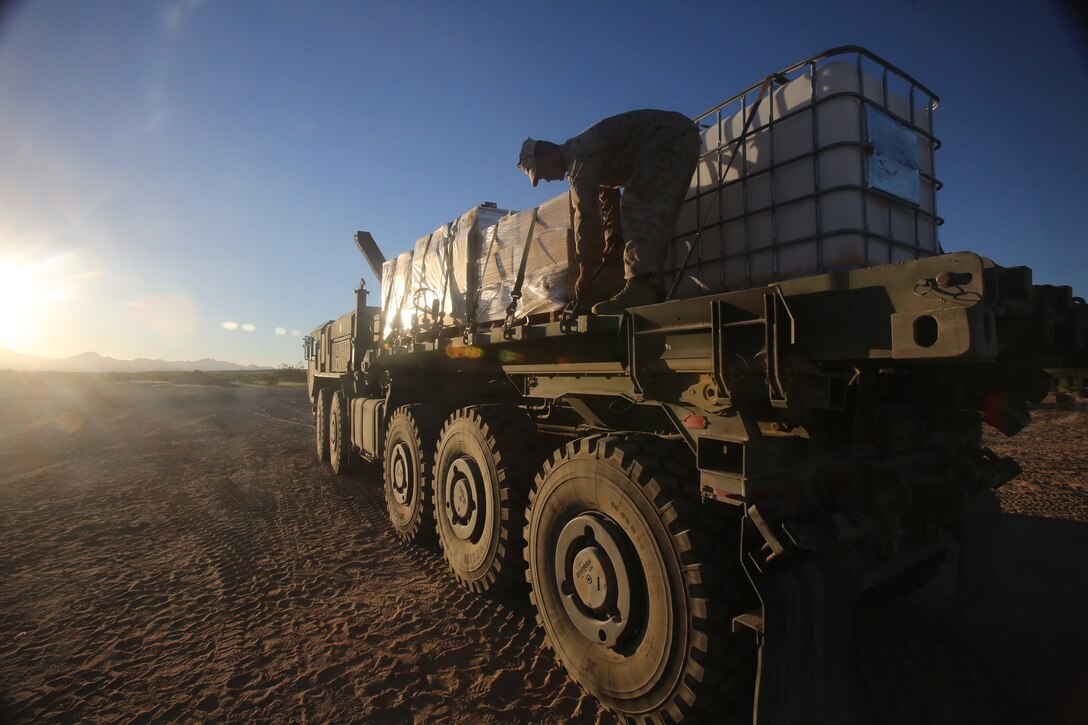 Lance Cpl. Salauddin Miah, a motor vehicle operator with General Support Motor Transport Company, Combat Logistics Regiment 1, 1st Marine Logistics Group, secures food rations to prepare for a supply convoy during Weapons and Tactics Instructor Course 1-14 in Yuma, Ariz., Oct. 3, 2013. Daily convoys were organized by CLC-16 to provide food, fuel and equipment across Arizona in support of WTI 1-14 and traveled as far as 350 miles for a single resupply operation. 