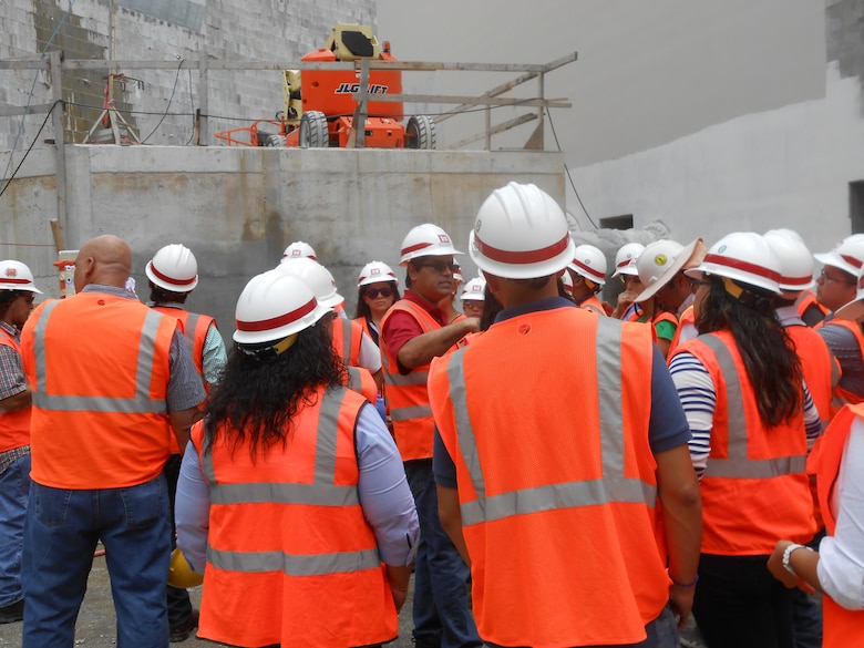 Pablo Vázquez-Ruiz (center) leads a tour of the Portugués Dam project for a group of engineering students from the American Concrete Institute, Polytechnic University of Puerto Rico.  As president of the Association of Engineers and Surveyors of Puerto Rico, Vázquez-Ruiz places a high priority on continuing education and on encouraging students to pursue degrees and careers in science, technology, engineering and math.  
