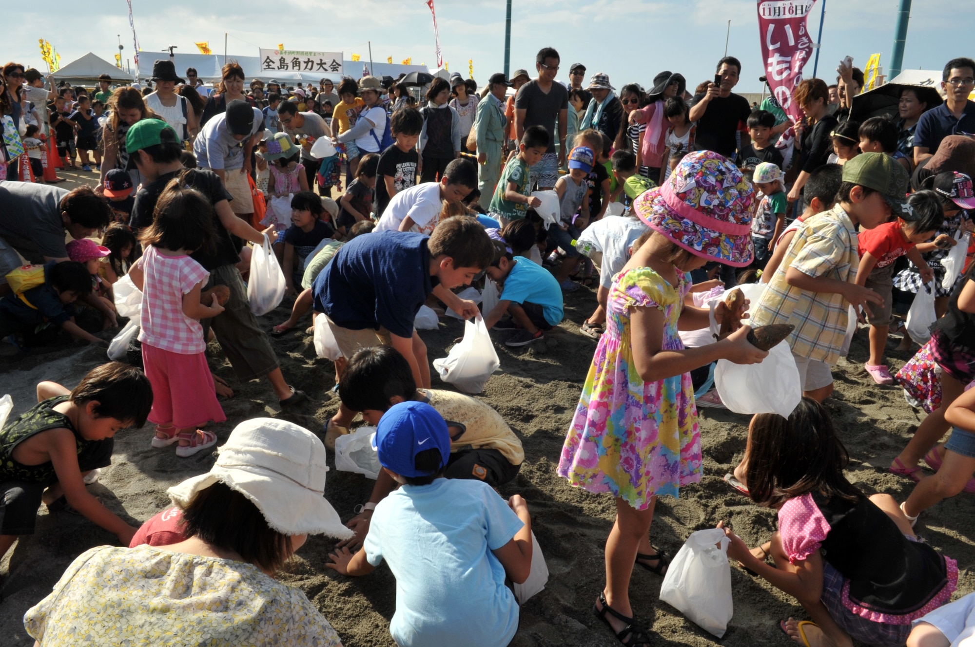 Children search for a potato in the “Potato digging competition,” during the 33rd Noguni Sokan Festival in Kadena Kaneku Seaside Park, Japan, Oct. 13, 2013. Noguni Sokan is a historical celebrity in Kadena, who introduced sweet potatoes from China over 400 years ago and was said to save the locals from starvation. (Courtesy photo)