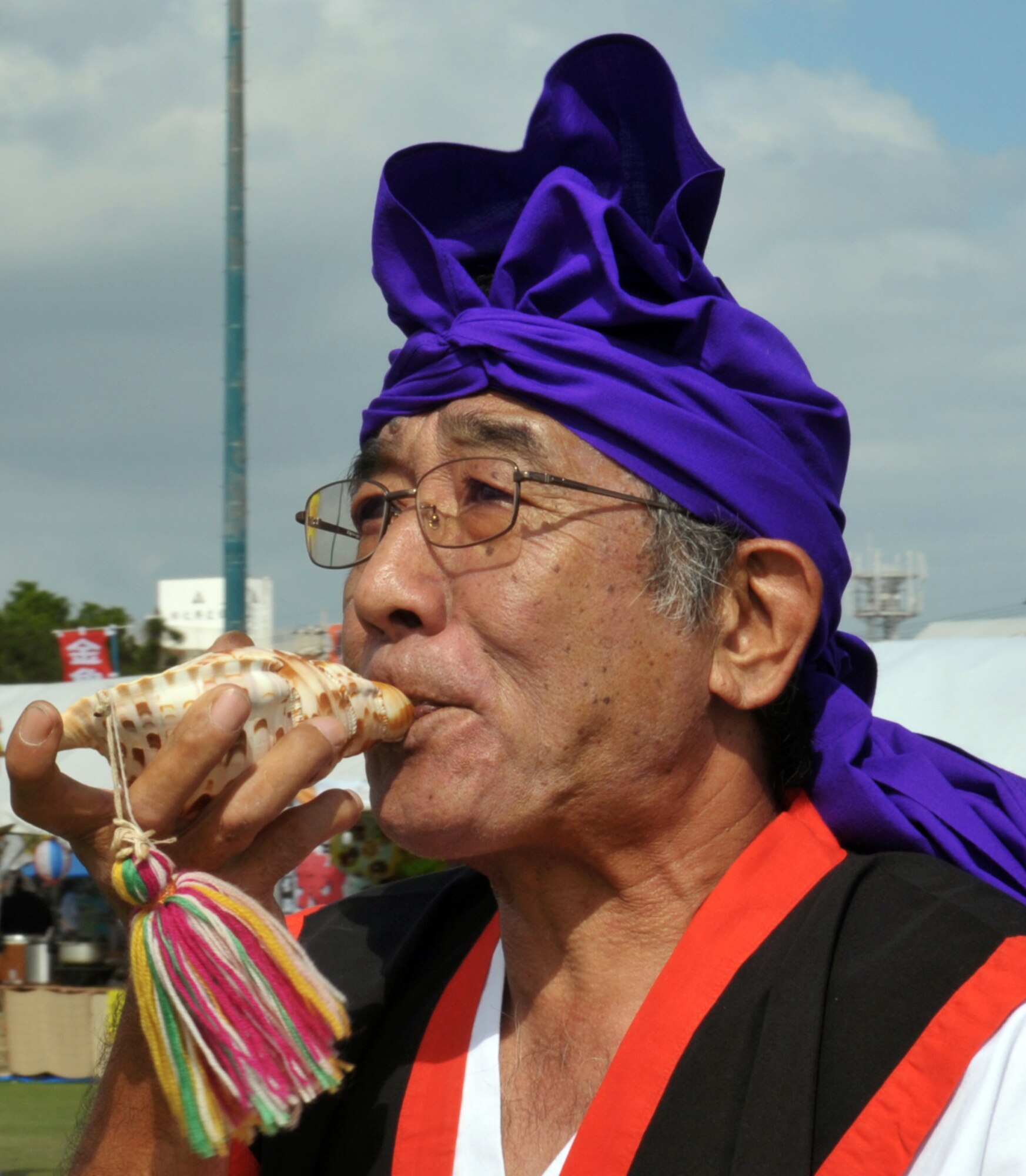 An Okinawan conch shell player plays to the rhythm of the parade during the 33rd Noguni Sokan Festival in Kadena Kaneku Seaside Park, Japan, Oct. 13, 2013. The festival included a parade, eisa, and dances by the Women's Institute and Kadena students to honor the outstanding virtue of Noguni Sokan. (Courtesy photo)