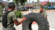 Master Sgt. Ricardo Russo, right, performs tire flips with a U.S. Marine Corps Staff Non-Commissioned Officer Academy classmate, during a physical training session at Camp Pendleton, Calif. Russo was the only Air Force member in his class, and was hand-picked to attend the course. (Courtesy photo)