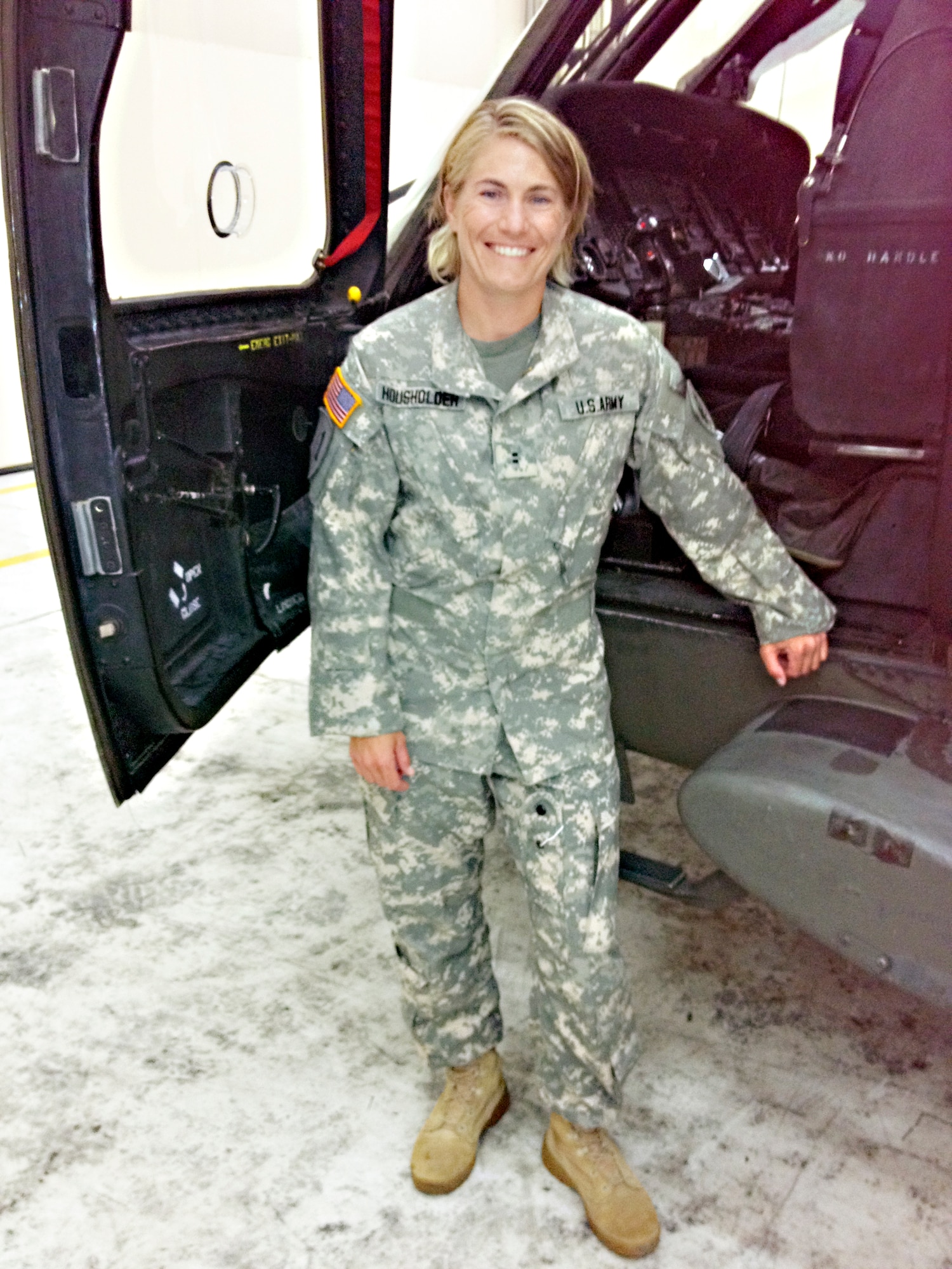 Army Chief Warrant Officer Two Jen Housholder stands in front of a UH-60 Blackhawk helicopter. Housholder works as an engineer in the 775th Test Squadron along with serving in the Army Reserve. (Courtesy photo)