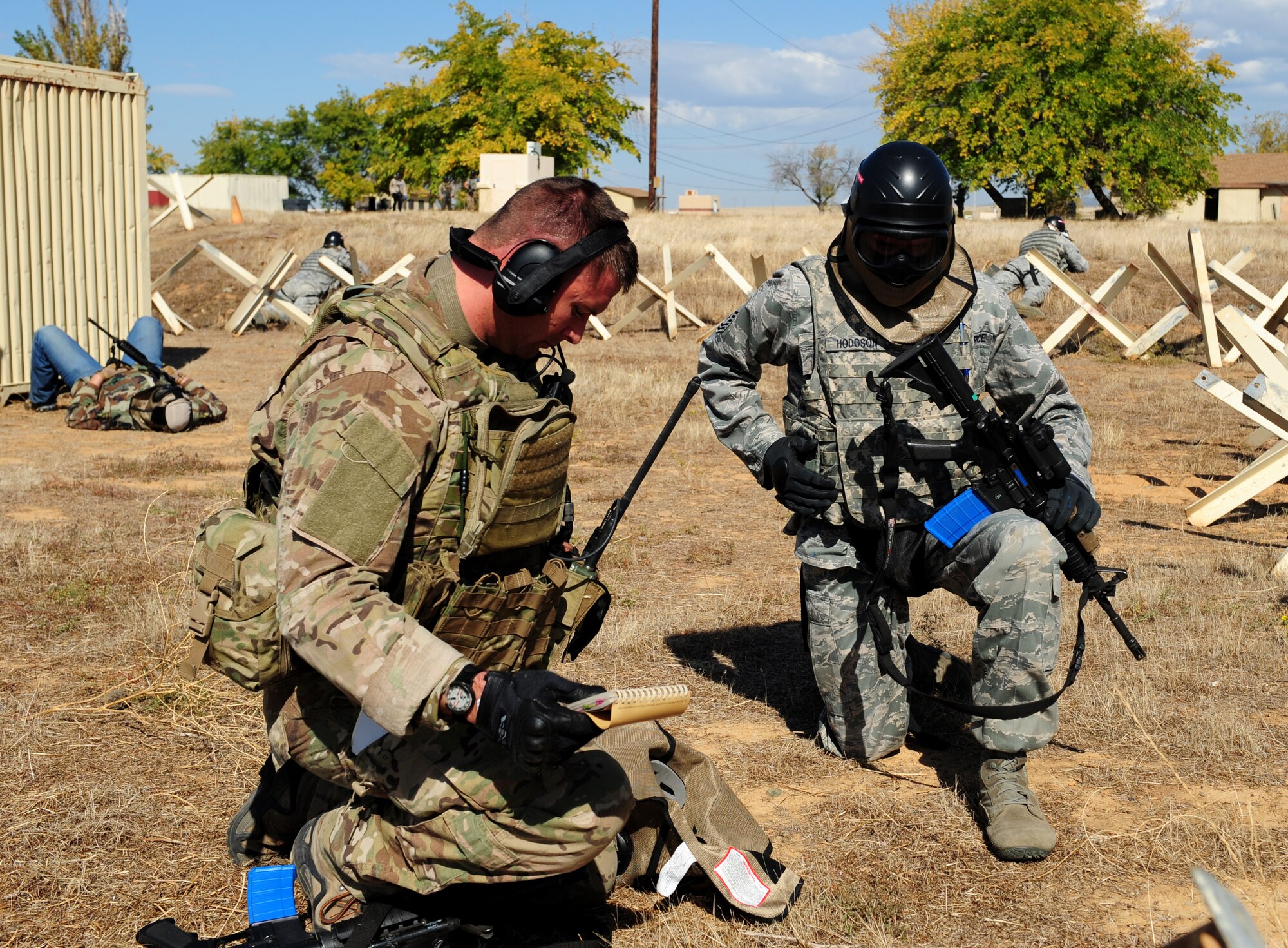 Master Sgt. Douglas Hodgson (right), 9th Security Forces Squadron flight chief, coordinates with an Air Force contractor during a pilot-rescue exercise at Beale Air Force Base, Calif., Oct. 9, 2013. The men were in contact with a MC-12W Liberty aircrew, which provided intelligence, surveillance and reconnaissance support during the exercise.  (U.S. Air Force photo by Airman 1st Class Bobby Cummings/Released)