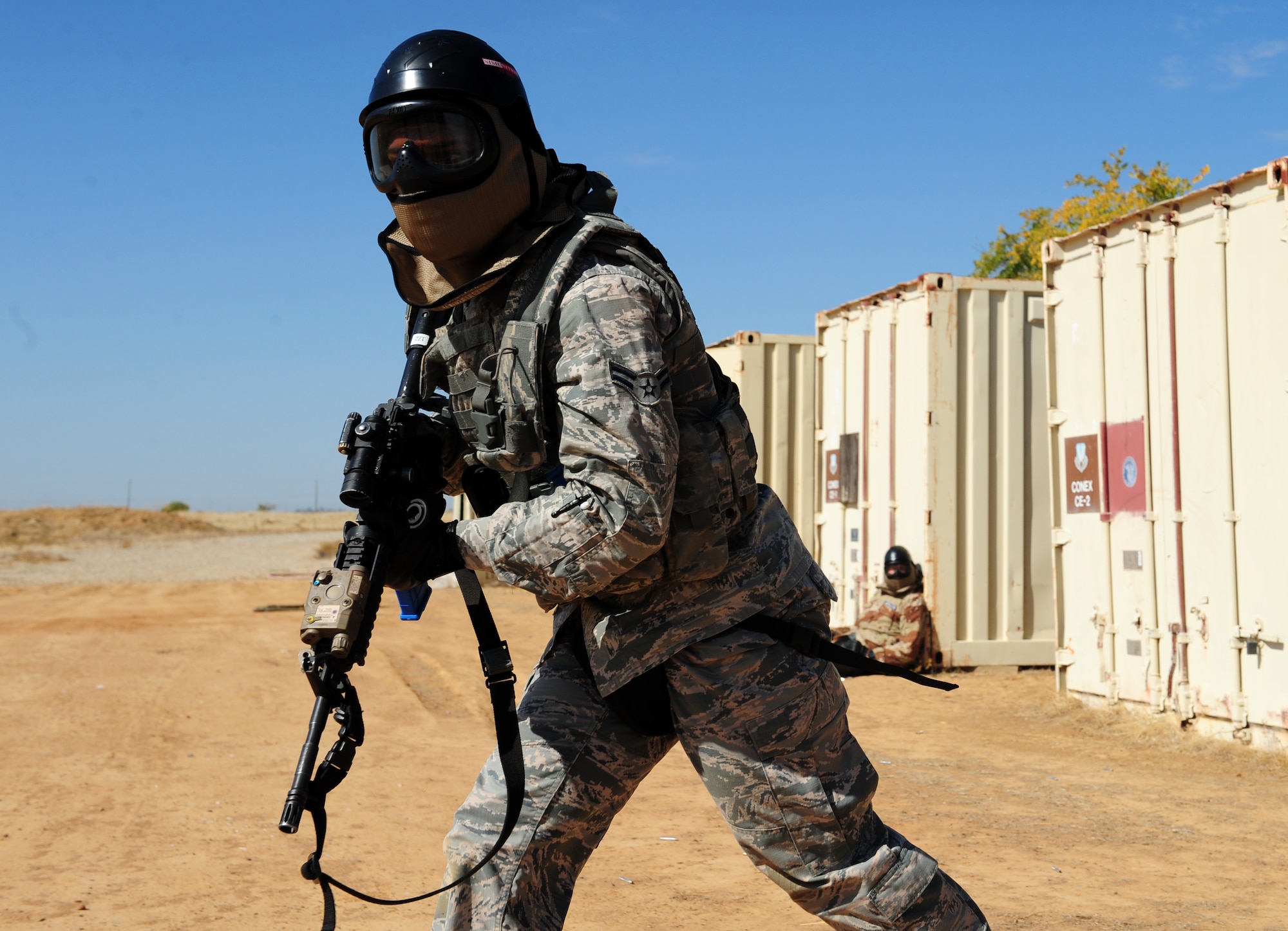 An Airman from the 9th Security Forces Squadron moves into position during a pilot-rescue exercise at Beale Air Force Base, Calif., Oct. 9, 2013. Airmen exchanged simulation munitions fire with opposition forces throughout the exercise, which offered more realism to the scenario. (U.S. Air Force photo by Airman 1st Class Bobby Cummings/Released)