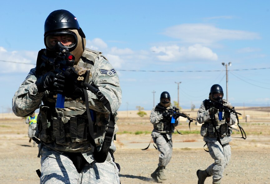 U.S. Air Force Airmen from the 9th Security Forces Squadron assault a simulated village during a pilot-rescue exercise at Beale Air Force Base, Calif., Oct. 9, 2013. The Airmen were able to practice combat maneuvers during the scenario. (U.S. Air Force photo by Airman 1st Class Bobby Cummings/Released) 