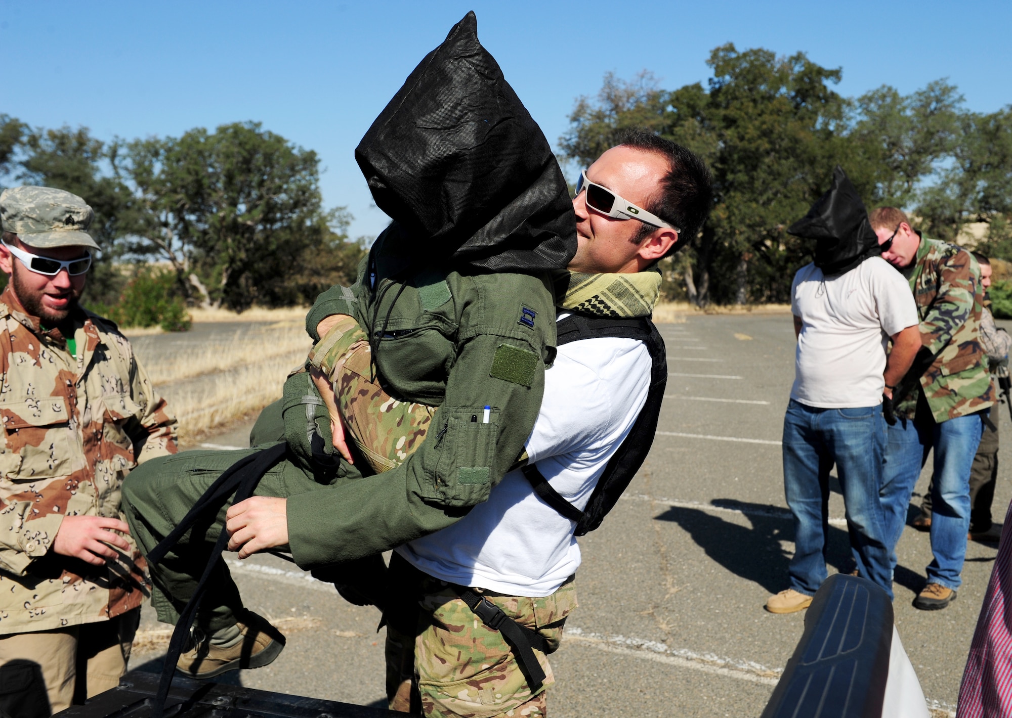 A captured pilot is loaded into a vehicle during a pilot-rescue exercise at Beale Air Force Base, Calif., Oct. 9, 2013. Air Force contractors acted as opposition forces throughout the exercise. (U.S. Air Force photo by Airman 1st Class Bobby Cummings/Released)