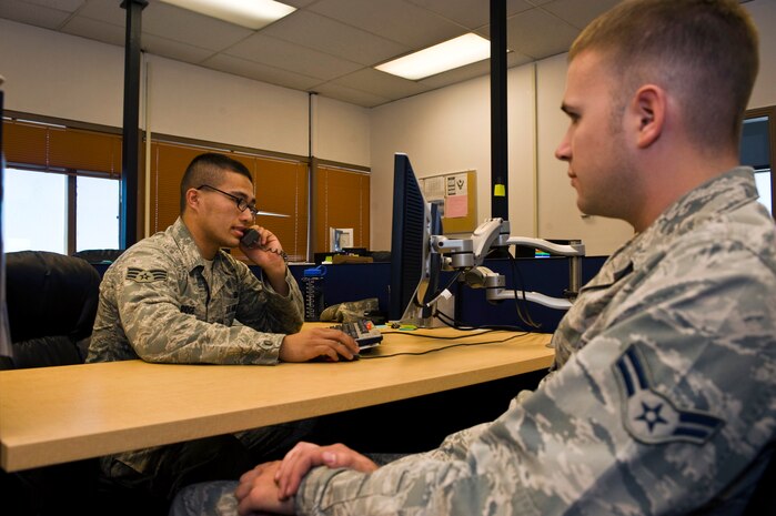 Senior Airman Timothy Ridge, 99th Force Support Squadron career development technician, provides Airman 1st Class Joseph Clayson, 99th Logistics Readiness Squadron vehicle operator, with information concerning his permanent change of station Oct. 11, 2013, at Nellis Air Force Base, Nev. Due to the government shut down, PCS assignments are on hold until further notice. (U.S. Air Force photo by Airman 1st Class Christopher Tam)