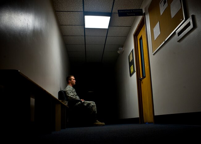 An Airman waits to take his Career Development Course end of course test Oct. 11, 2013, in the hall at the 99th Force Support Squadron Military Personnel Section on Nellis Air Force Base, Nev. The 99th FSS will continue to provide professional military education testing throughout the government shutdown.  (U.S. Air Force photo by Staff Sgt. Michael Charles)
