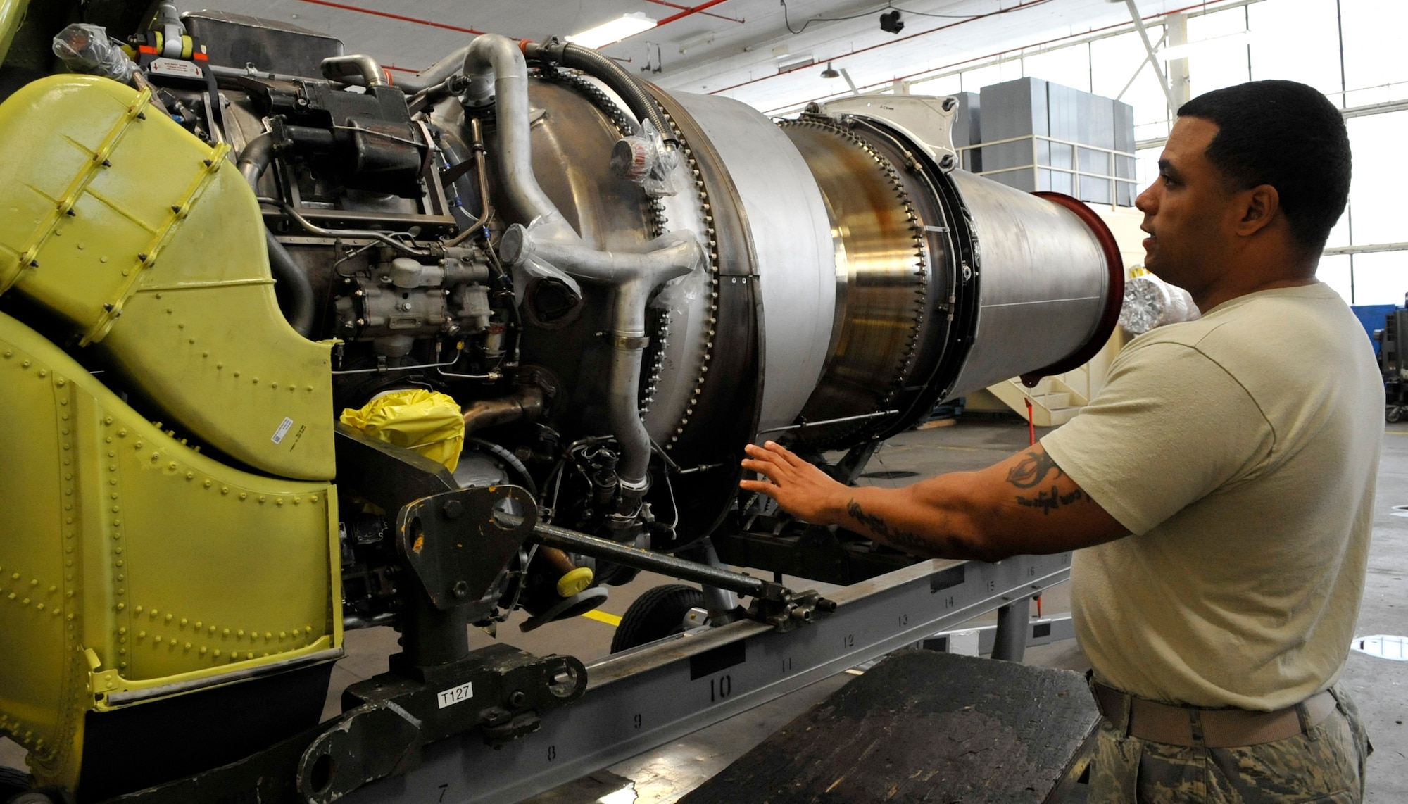 Tech. Sgt. William Cheese, 2nd Maintenance Squadron engine trending and diagnostics monitor, demonstrates how a piece of foreign object debris can enter a B-52H Stratofortress engine and damage its turbines on Barksdale Air Force Base, Oct. 10, 2013. If damage to the engine is great enough, it will be shipped to Tinker Air Force Base, Okla., for an investigation and complete repair. (U.S. Air Force Photo/Airman 1st Class Benjamin Raughton)