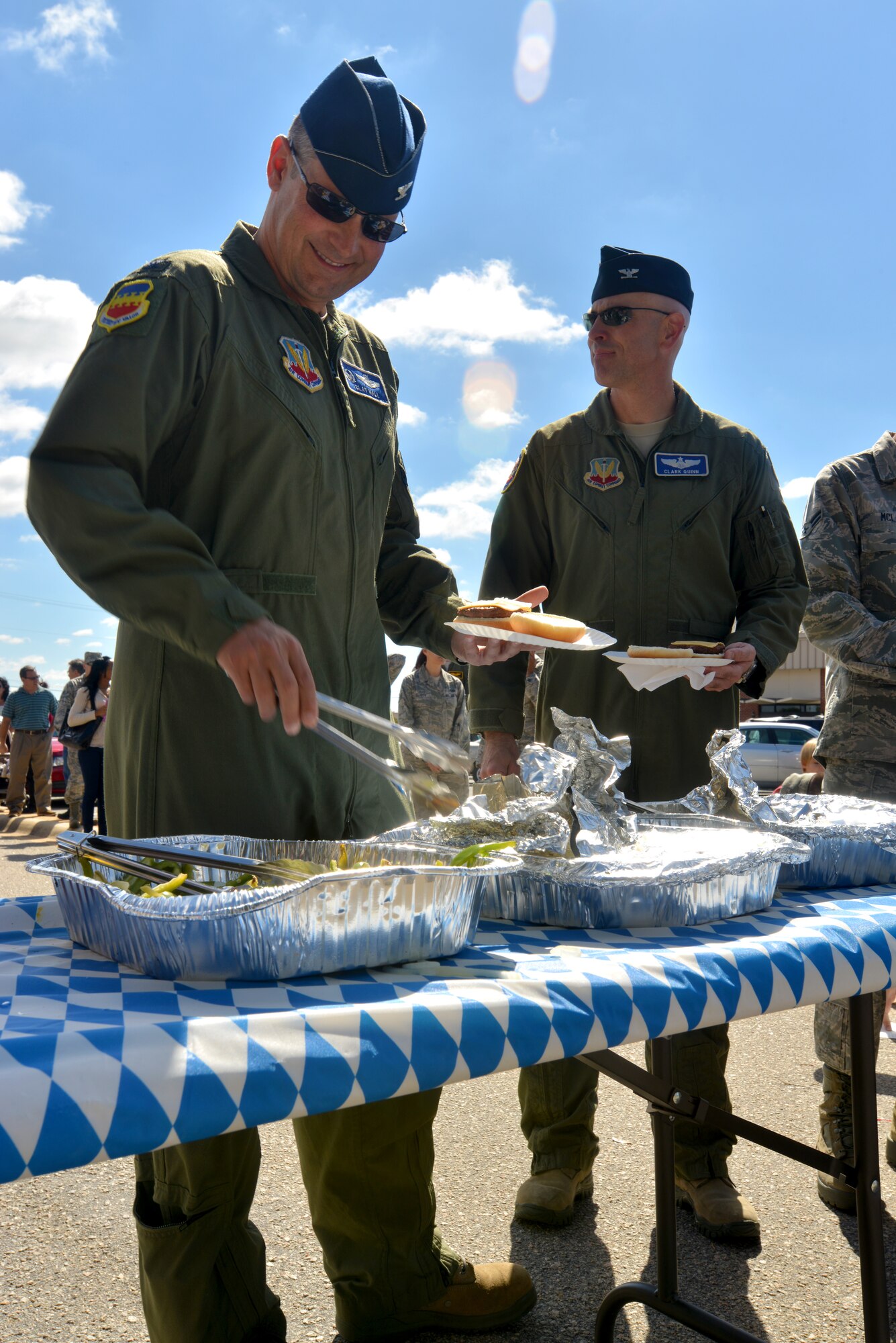 U.S. Air Force Col. Clay Hall, 20th Fighter Wing commander, picks up food while going through a food line during a first sergeant appreciation picnic, Shaw Air Force Base, S.C., Oct. 10, 2013. The Oktoberfest-themed picnic was held to celebrate the Enlisted Attic’s grand re-opening; a place for free clothing, uniforms, and household items for E-5 and below and their dependents.  (U.S. Air Force photo by Airman 1st Class Jensen Stidham/Released)