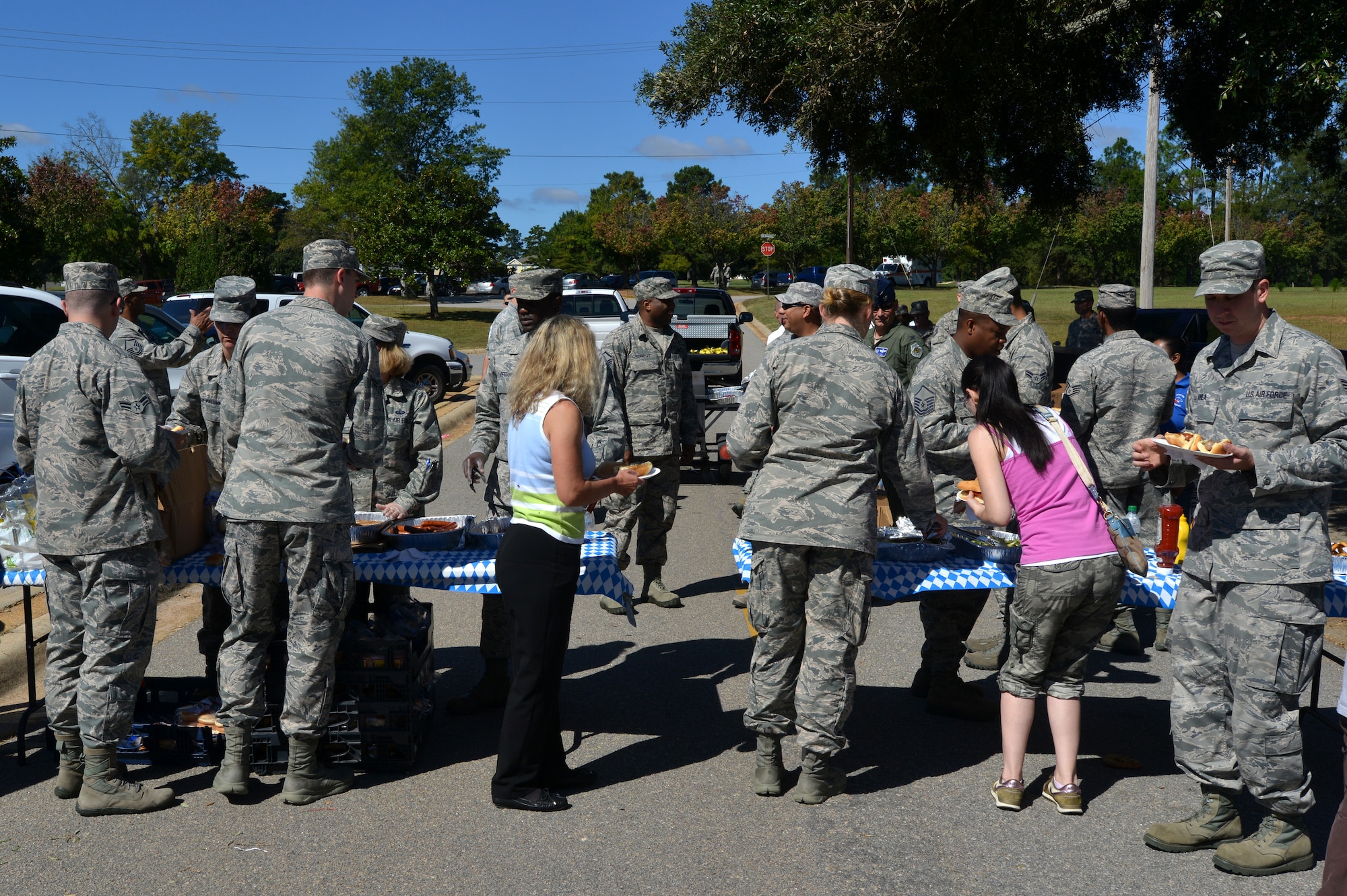 U.S. Air Force Airmen go through a food line during a first sergeant appreciation picnic, Shaw Air Force Base, S.C., Oct. 10, 2013. The Oktoberfest-themed picnic was held to celebrate the Enlisted Attic’s grand re-opening; a place for free clothing, uniforms, and household items for ranks E-5 and below and their dependents. .  (U.S. Air Force photo by Airman 1st Class Jensen Stidham/Released)