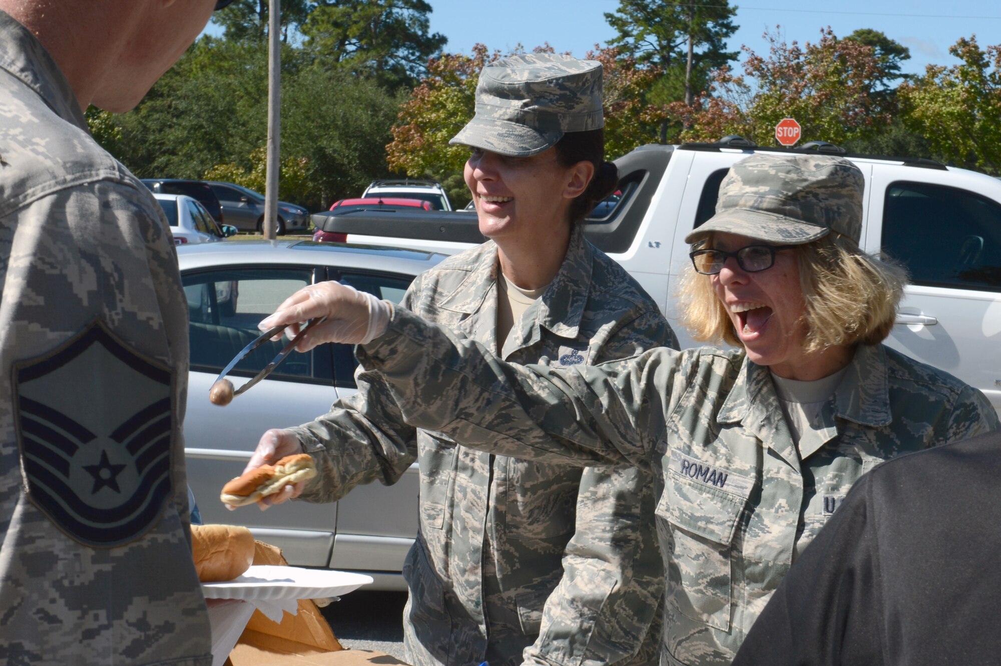 U.S. Air Force Master Sgt. Nancy Barron-Palumbo, 9th Air Force superintendent and additional-duty first sergeant, and Master Sgt. Rhonda Roman, 20th Component Maintenance Squadron first sergeant, serve up food at a first sergeant appreciation picnic at Shaw Air Force Base, S.C., Oct. 10, 2013. The picnic was inspired by Oktoberfest and held jointly with the grand re-opening of Shaw’s Enlisted  Attic. (U.S. Air Force photo by Airman 1st Class Jonathan Bass/Released)