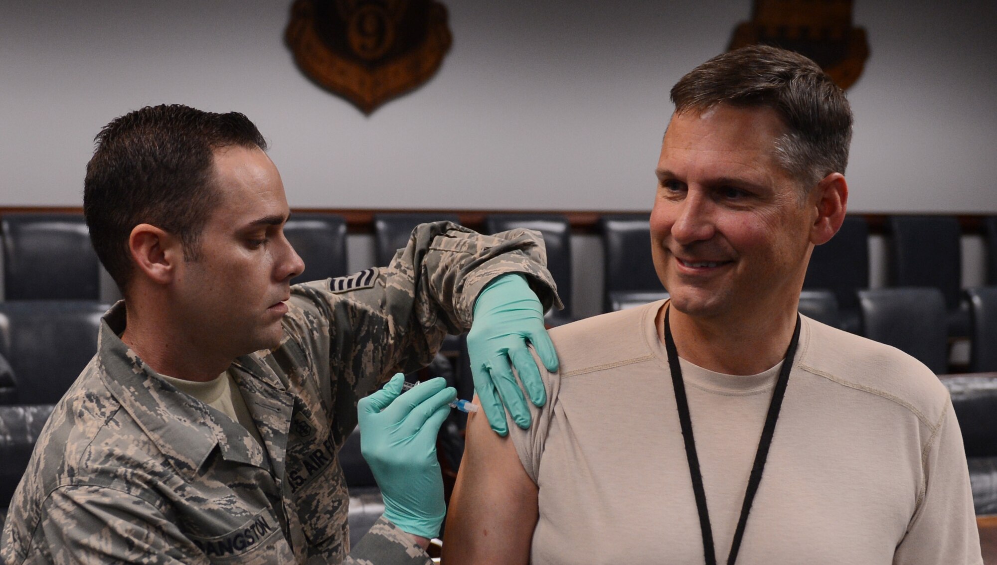 U.S. Air Force Tech. Sgt. Richard Sangston, 20th Medical Group allergy and immunizations technician, gives Col. Clay Hall, 20th Fighter Wing commander, his annual flu vaccination, Shaw Air Force Base, S.C., Oct. 11, 2013. All active-duty and medical personnel are required to receive their annual flu vaccination. (U.S. Air Force photo by Senior Airman Tabatha Zarrella/Released) 
