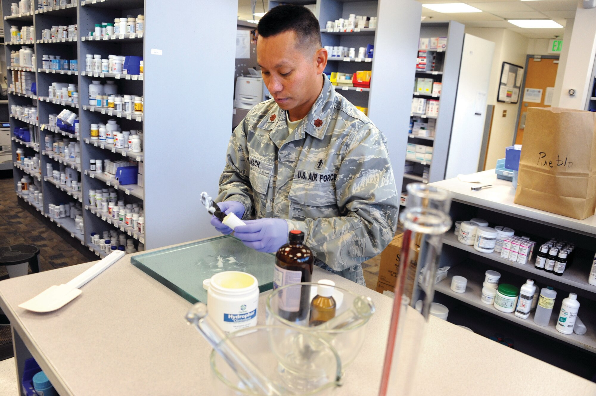 Maj. Andre Mach mixes an ointment compound at the 10th Medical Support Squadron Pharmacy Wednesday. (U.S. Air Force Photo/Carol Lawrence)