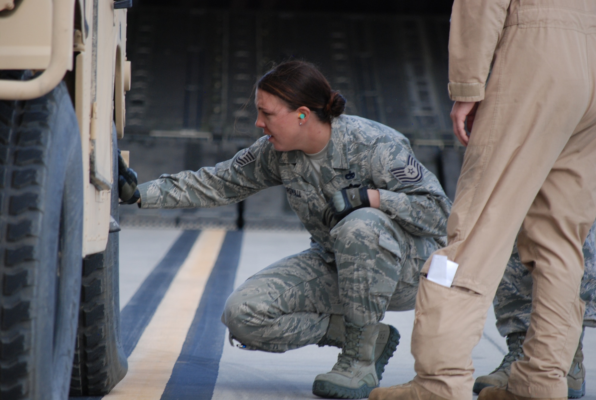 COLORADO SPRINGS, Colo. – Tech. Sgt. Kristina Marshall, 21st Logistics Readiness Squadron, inspects a vehicle tire for low air pressure during embarkation operations at the Fort Carson Arrival/Departure Airfield Control Group Oct. 9. Air terminal operations at the Army facility are conducted by a team of 15 Airmen from Peterson’s 21st Logistics Readiness Squadron. (U.S. Air Force photo/Michael Golembesky)