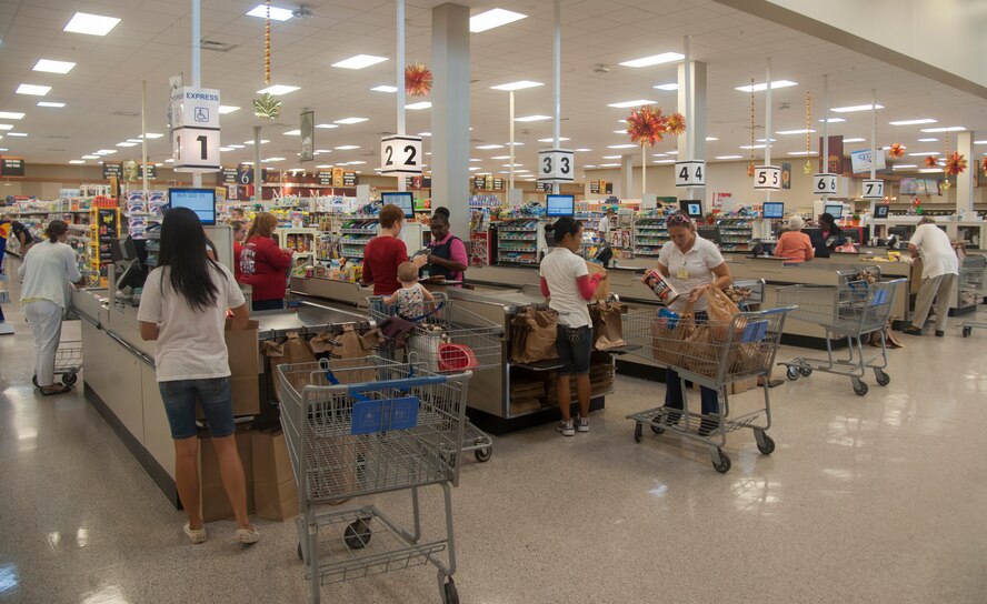 Commissary cashiers and baggers process shoppers through the checkout line during the reopening at Moody Air Force Base, Ga., Oct. 8, 2013. The commissary was left closed Oct. 2 due to the federal government shutdown. (U.S. Air Force Photo by Airman Dillian Bamman/Released)