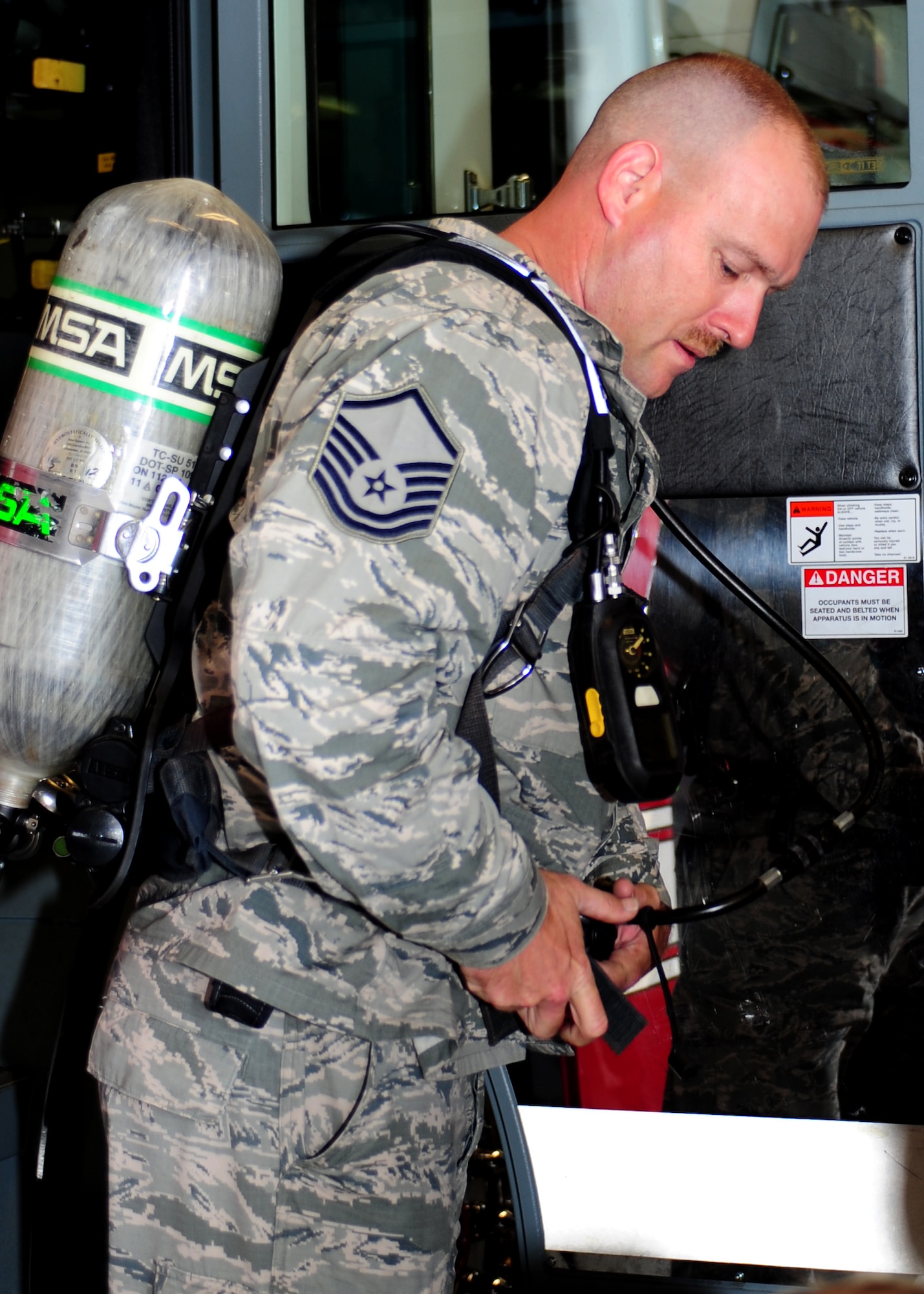 U.S. Air Force Master Sgt. Robert Fox, 633rd Civil Engineer Squadron fire inspector, shows Fire Prevention Week attendees gear used by 633rd CES firefighters during the fire department open house at the Langley Air Force Base, Va., Oct. 11, 2013. The open house was held daily Oct. 6-12 in support of Fire Prevention Week. (U.S. Air Force photo by Airman Areca T. Wilson/Released)