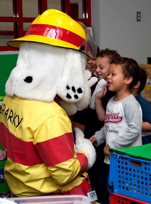 Sparky the fire dog visits the Langley Child Development Center during Fire Prevention Week at Langley Air Force Base, Va., Oct. 10, 2013. In addition to educating individuals on how prevent kitchen fires, 633rd Civil Engineer Squadron firefighters, with the help of Sparky, also covered the importance of having an evacuation plan and what actions to take in the event of a fire. (U.S. Air Force photo by Airman Areca T. Wilson/Released)
