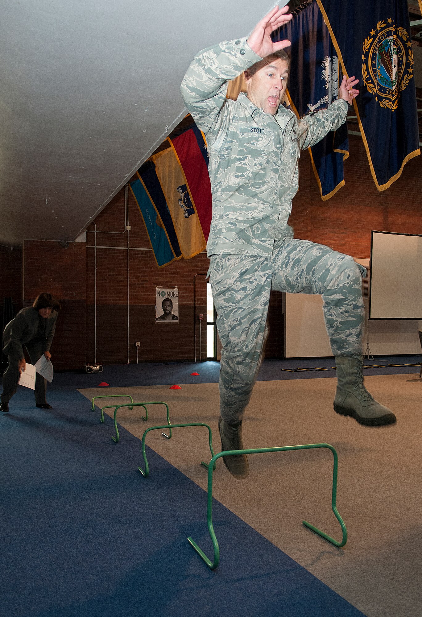 Chief Master Sgt. Wayne Stott, 90th Medical Group chief, clears a hurdle while participating in the F.E. Warren Air Force Base Domestic Violence Awareness Confidence Course Challenge in the Fall Hall Community Center Oct. 10, 2013. The event, sponsored by the Domestic Violence Awareness Committee, included informational displays and physical challenges to bring attention to domestic violence. (U.S. Air Force photo by R.J. Oriez)