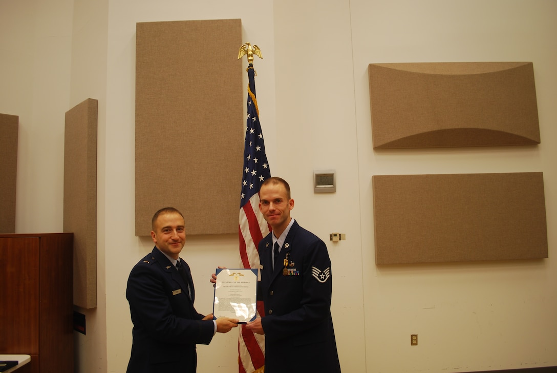 2nd Lieutenant Justin W. Lewis presents Staff Sergeant James Lantz with an Air Force Commendation Medal