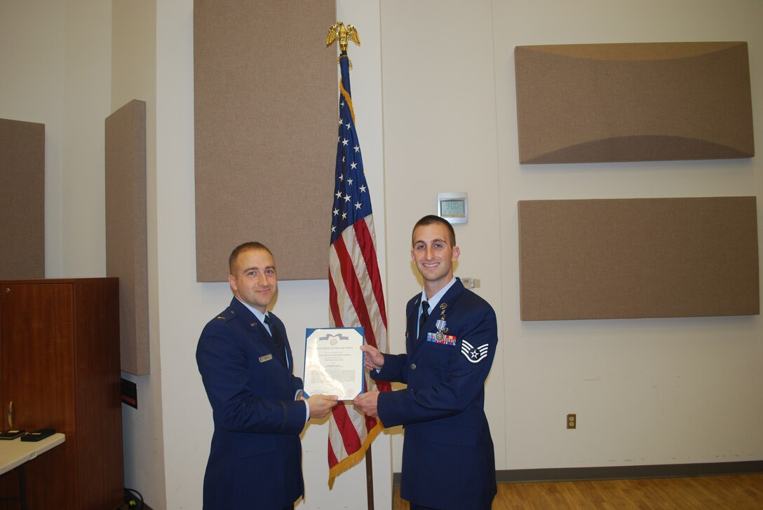 2nd Lieutenant Justin W. Lewis presents Staff Sergeant Aaron Weibe with an Air Force  Achievement Medal