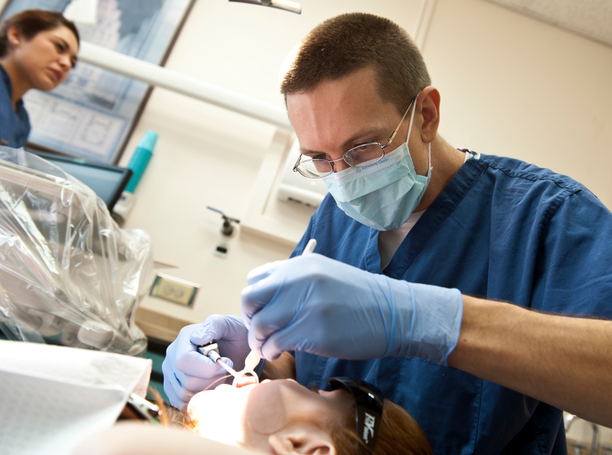 Capt. (Dr.) Matthew Miller, 39th Medical Operations Squadron dentist, examines the teeth of a military dependent Oct. 12, 2013, at Incirlik Air Base, Turkey. The dental day for dependents was run by volunteers from the 39th Medical Group who came in on their day off. (U.S. Air Force photo by Senior Airman Daniel Phelps/Released)