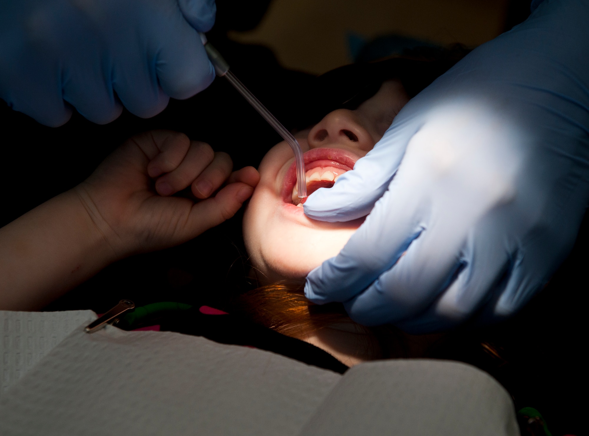 A dental screening is performed on a military dependent Oct. 12, 2013, at Incirlik Air Base, Turkey. The dental clinic set aside this Saturday for military dependents who might not get the opportunity to have appointments to receive a screening. (U.S. Air Force photo by Senior Airman Daniel Phelps/Released)